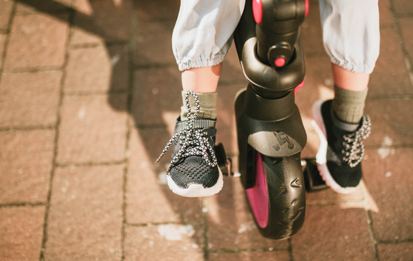 a child's feet on a tricycle