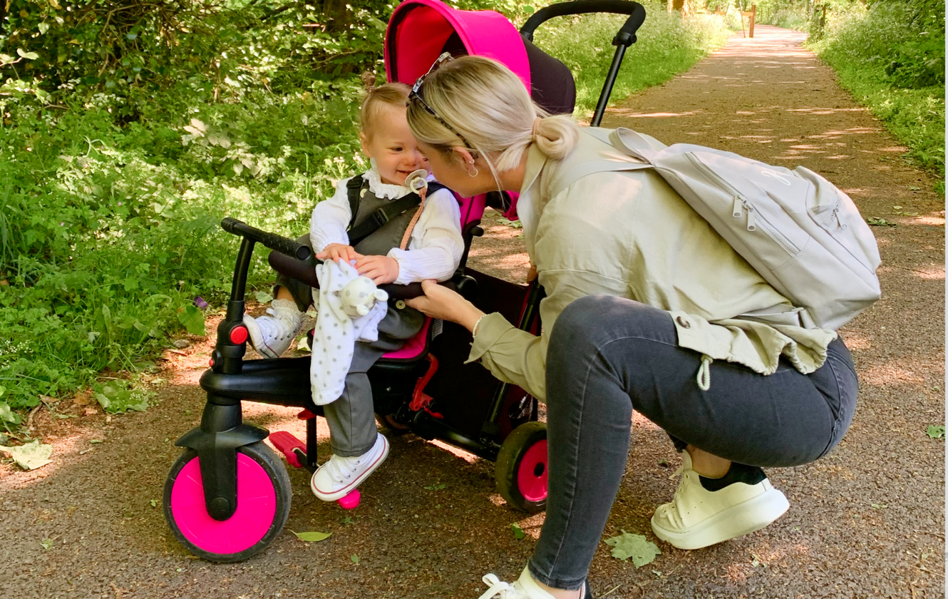 a woman pushing a baby in a stroller