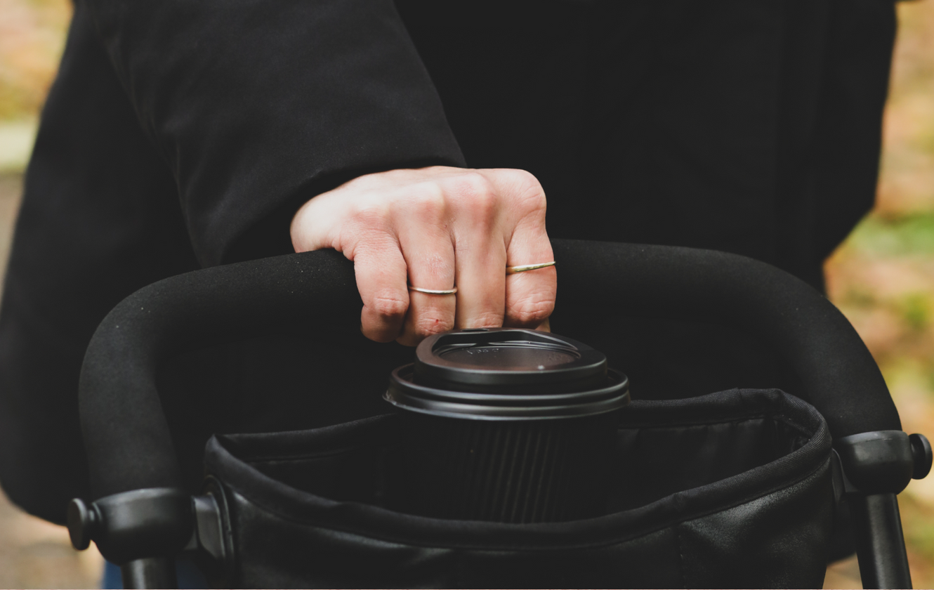 a hand holding a cup of coffee
