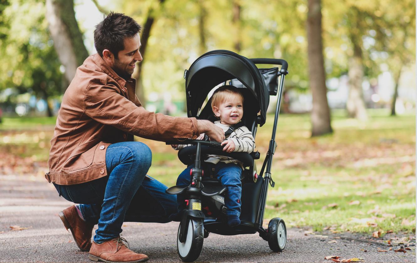 a man pushing a baby in a stroller